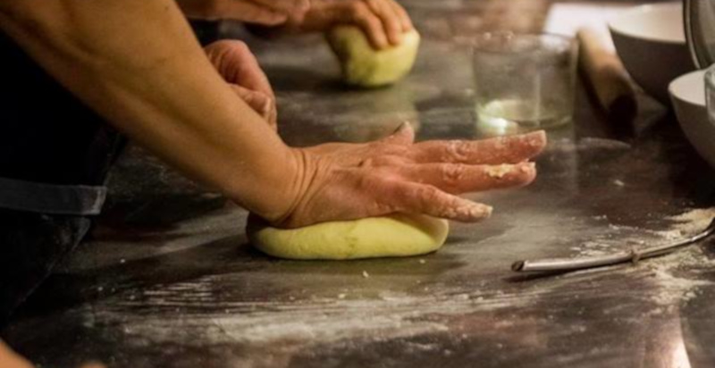 Chef che insegna tecniche culinarie in un corso di cucina a Milano
